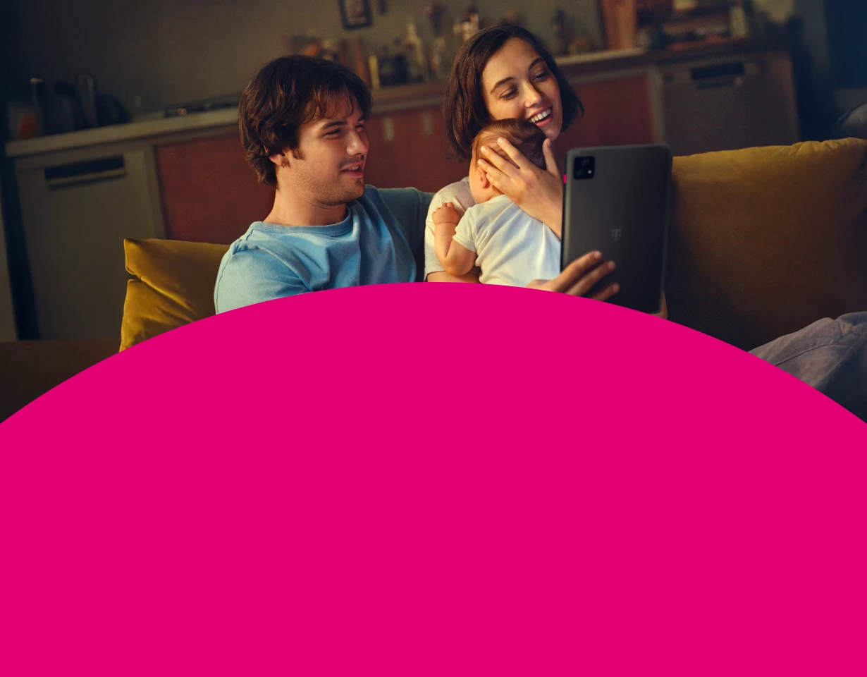 Junge Familie genießt schnelles Internet auf einem Tablet mit 250 MBit/s Angebot der Telekom